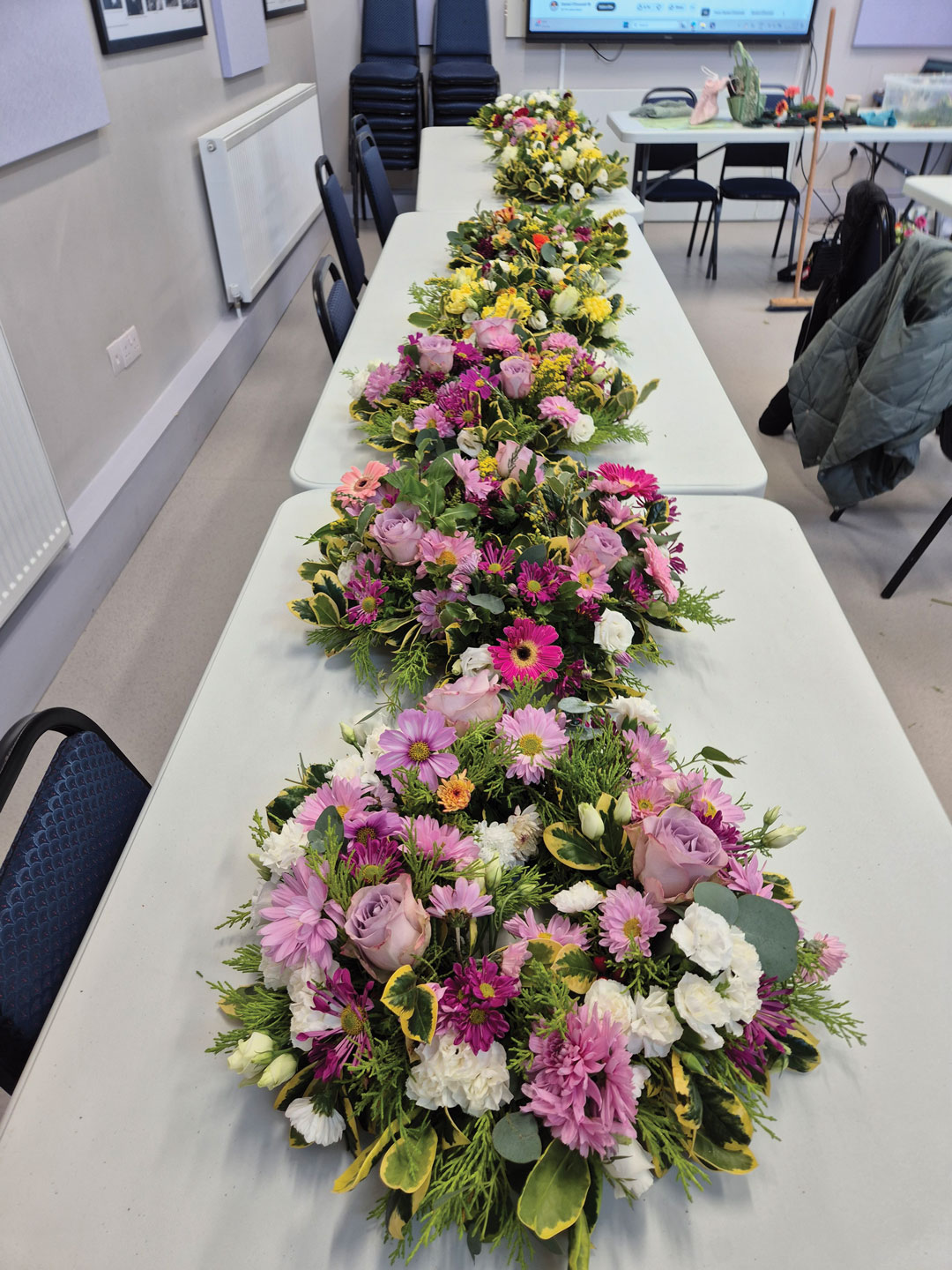 Olivias Flowers pink arrangements over white tables